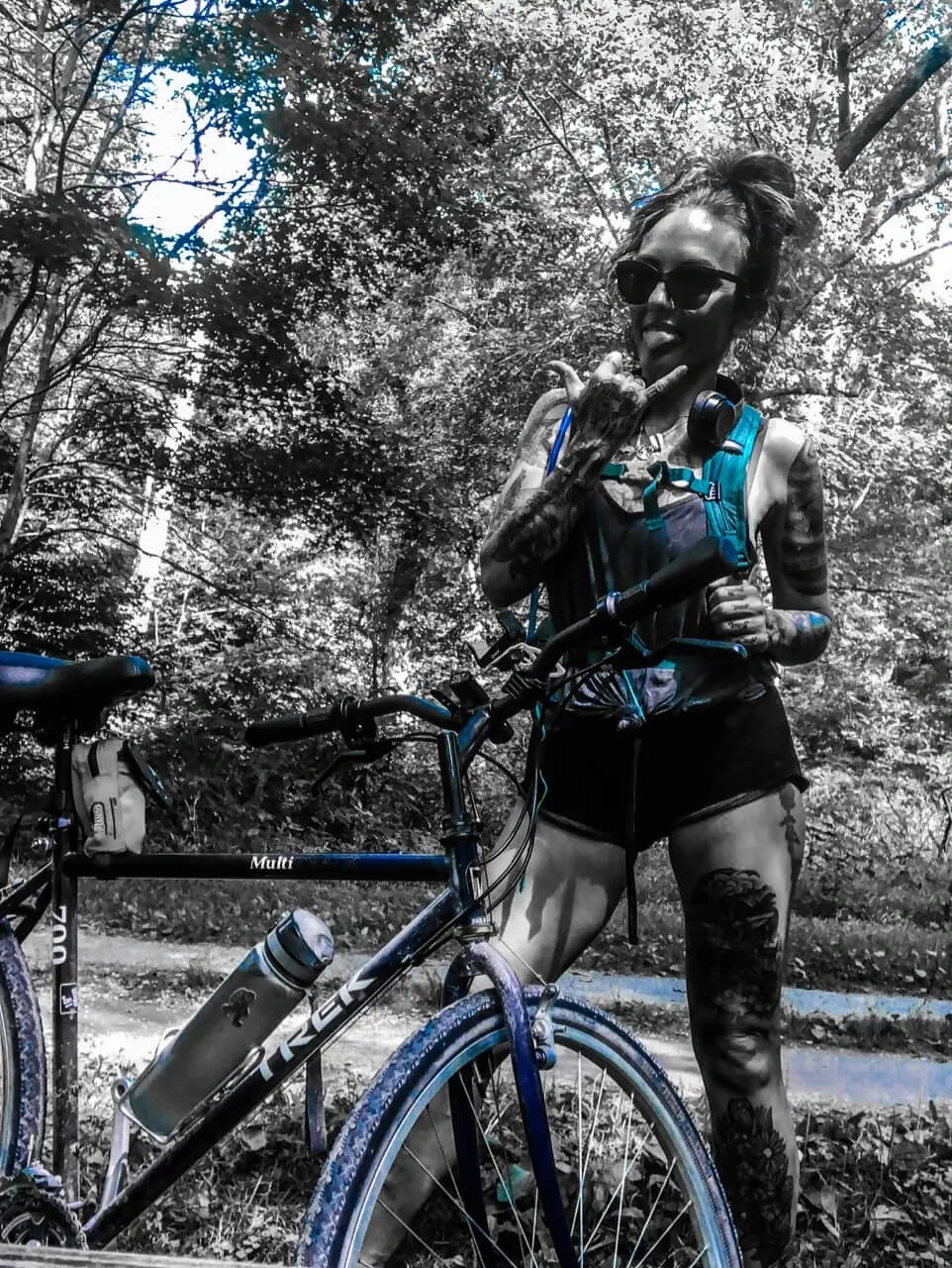 Photo of KDM posing next to bicycle on trail ride